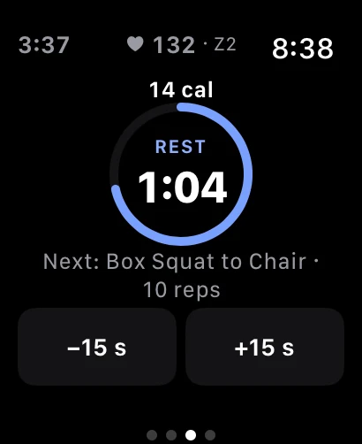 Apple Watch rest timer counting down from 1:04 in a circular ring, naming the next exercise as Box Squat to Chair for 10 reps, with minus and plus fifteen second buttons.